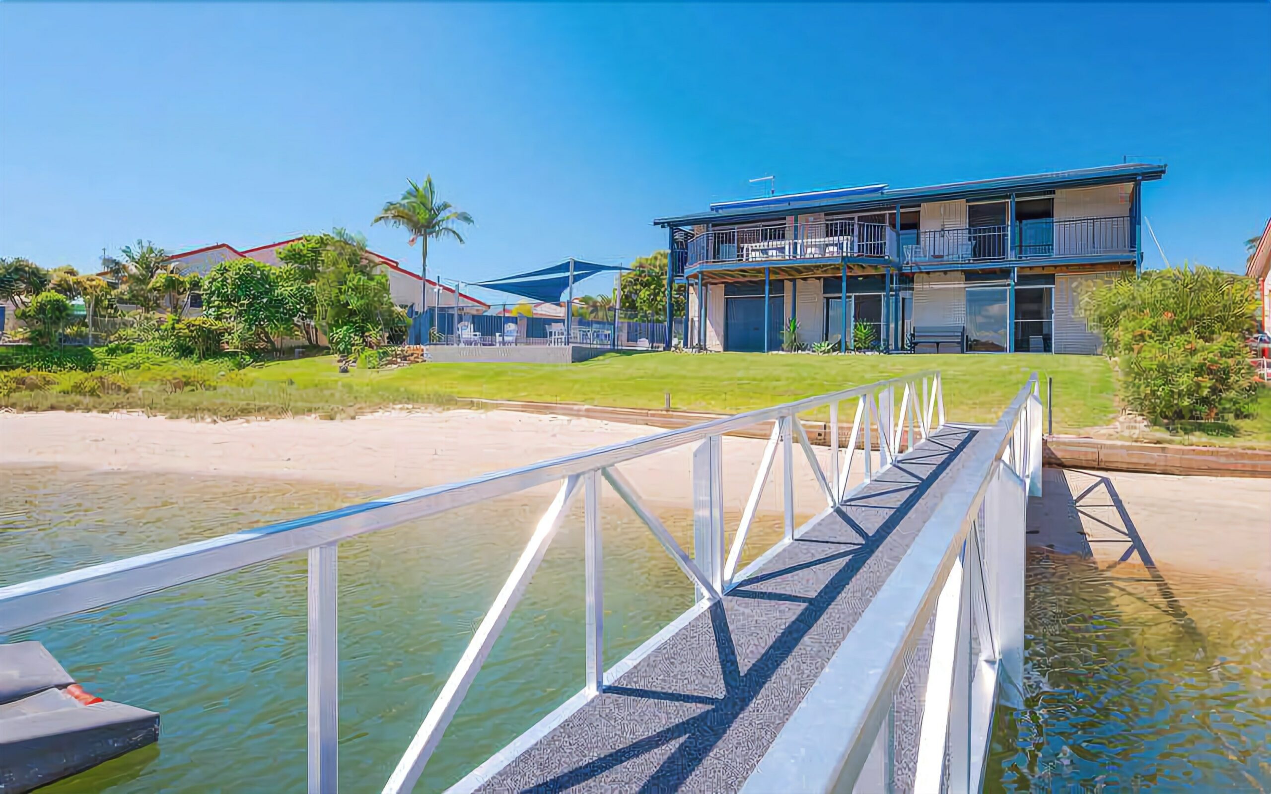 Stunning double story beach house on the waterfront with a pontoon and swimming pool!