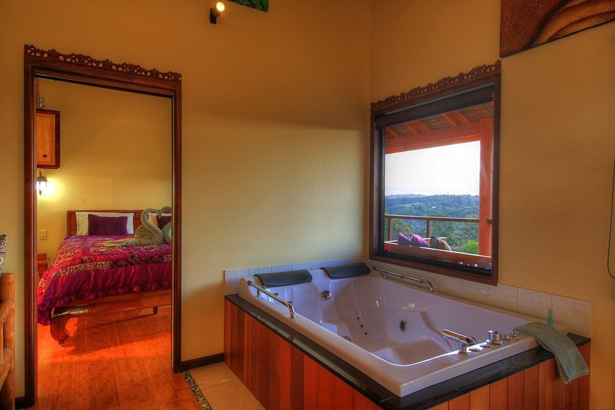 Luxury self-contained villa with two rooms, king and queen beds, double spa, fireplace, and kitchen.